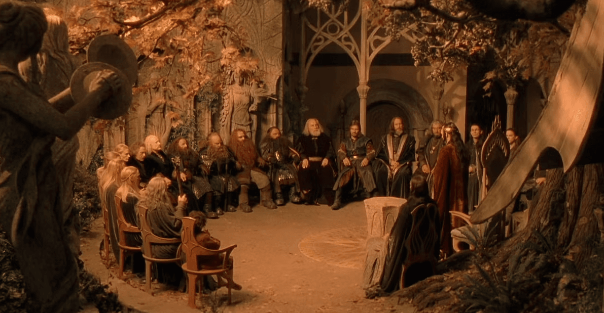 A screencap from The Lord of the Rings: The Fellowship of the Ring depicting a council of elves, dwarves, hobbits, and men.