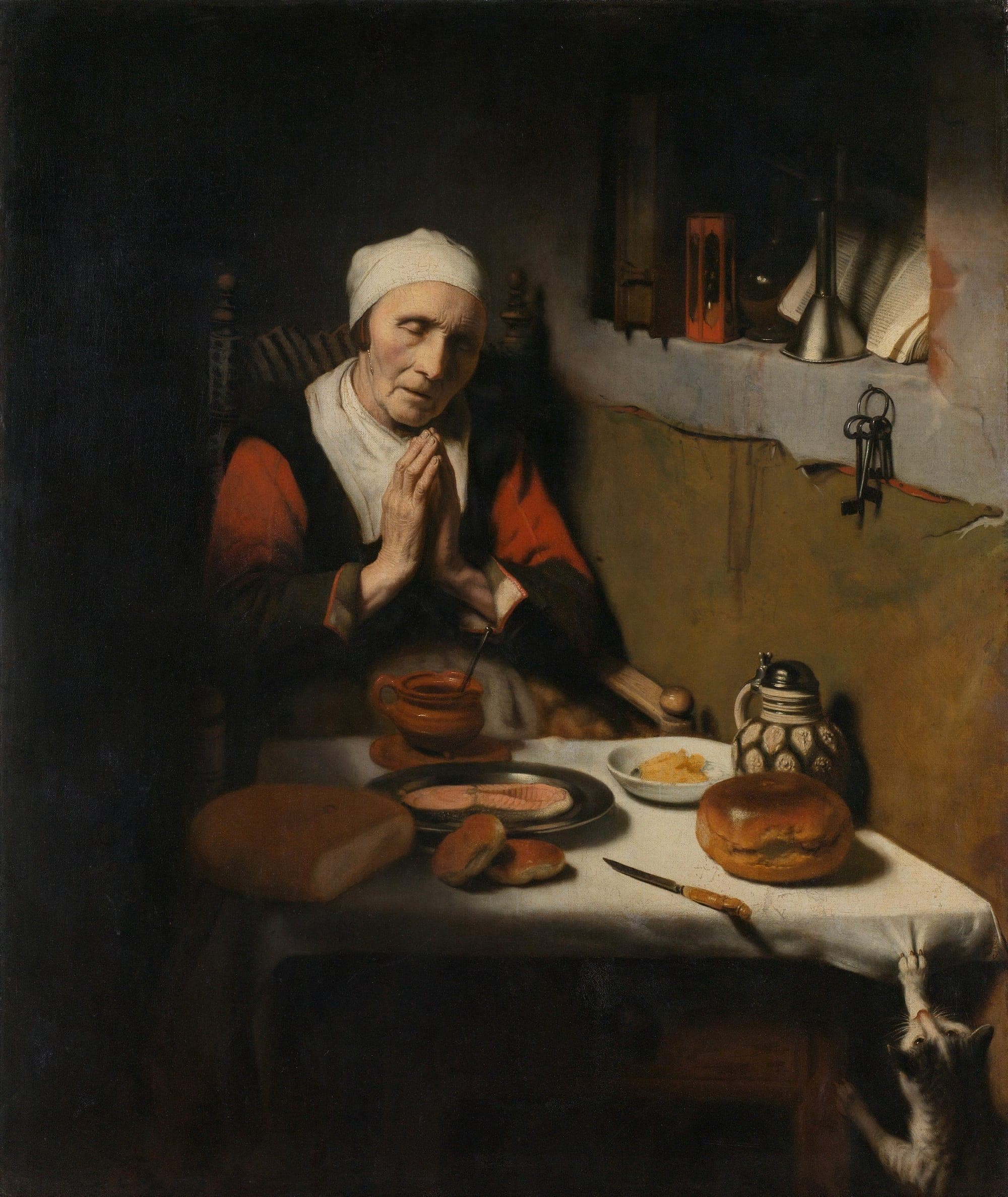 A portrait of a woman praying over a table laid with food.